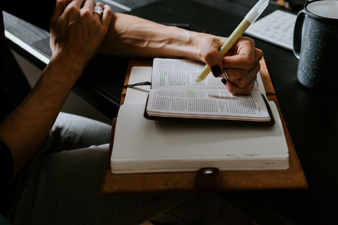 author writing at desk with notebook